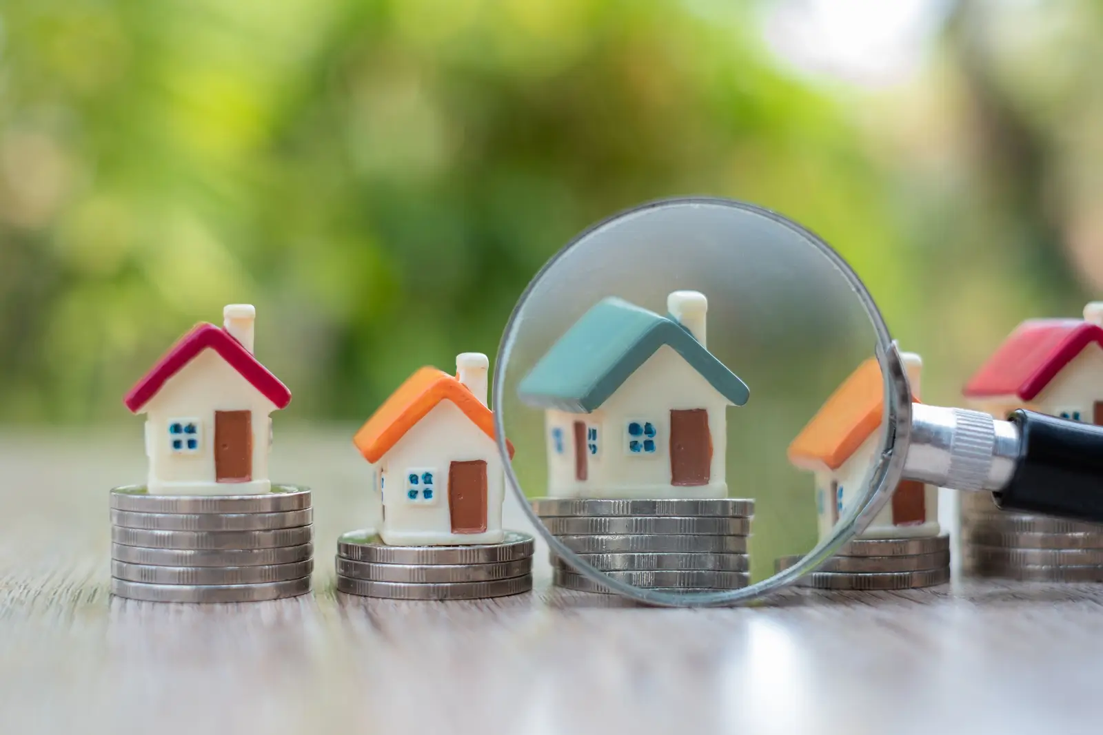 Magnifying glass over property documents representing thorough tenant screening and due diligence